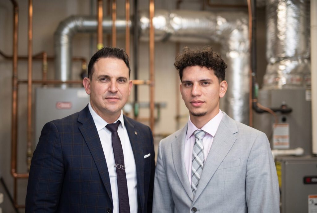 Gabriel Alberto and Carlos David of K&G Builders HVAC in a mechanical room